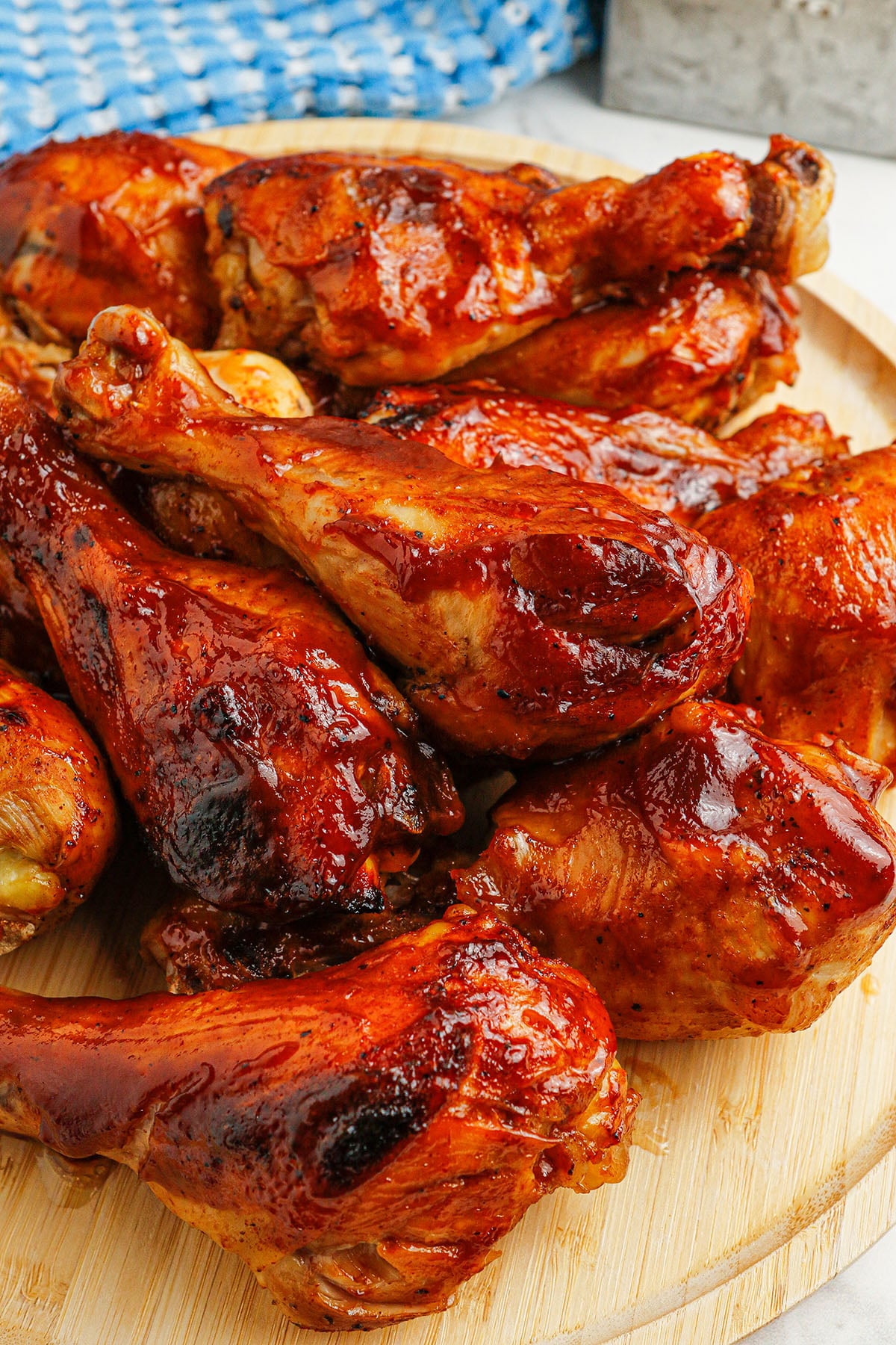  BBQ Chicken Drumsticks  served on a round wooden board.
