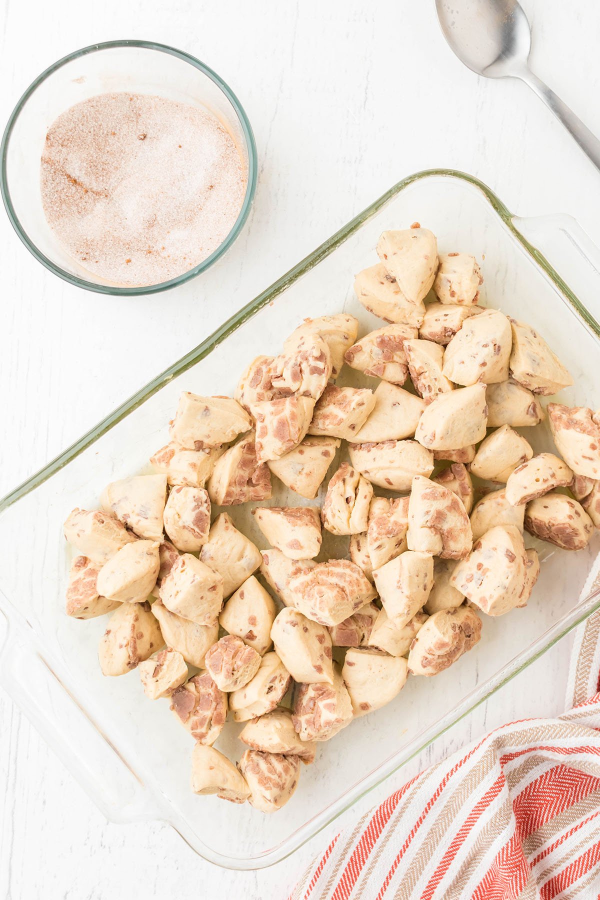 Cut cinnamon rolls in the bottom of a glass casserole dish.