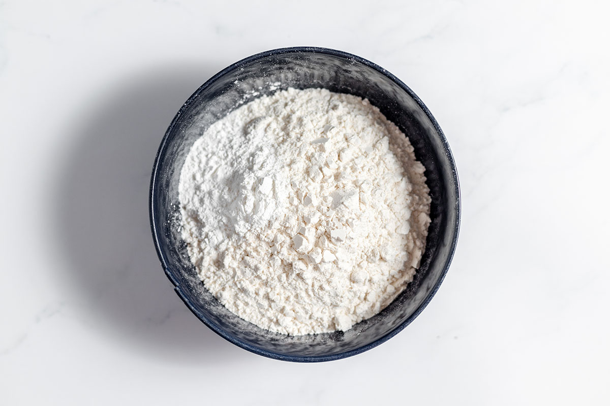 Flour, baking powder, and salt in a bowl.