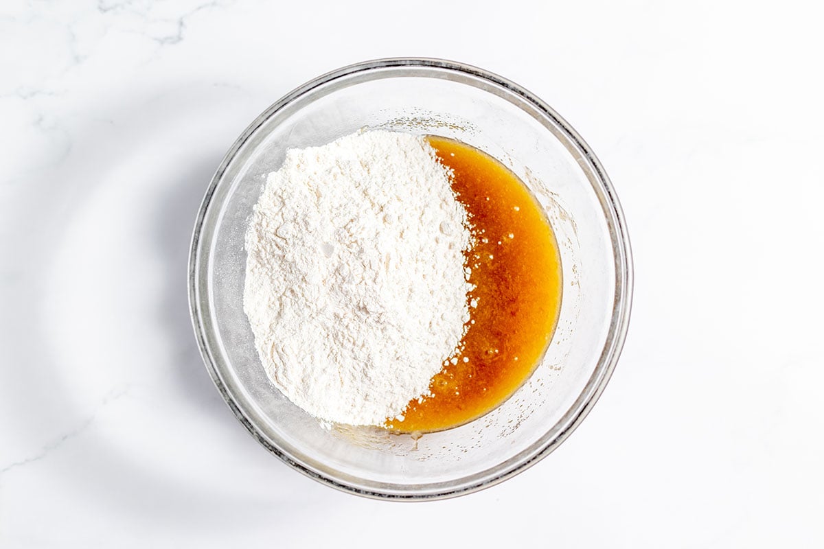 Flour mixture added to the wet ingredients in the mixing bowl.