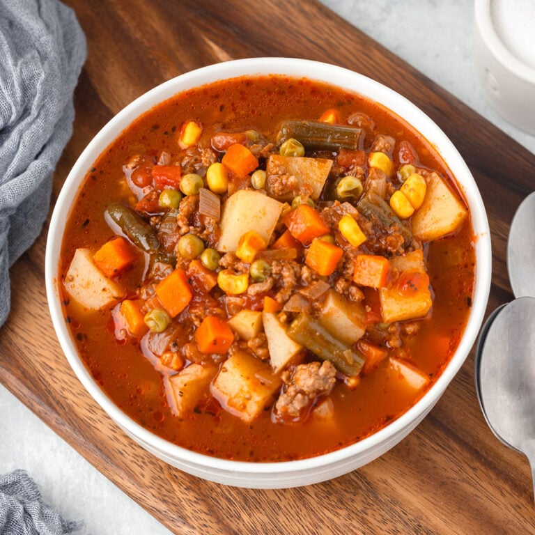 A serving of Hamburger Vegetable Soup in a white bowl.