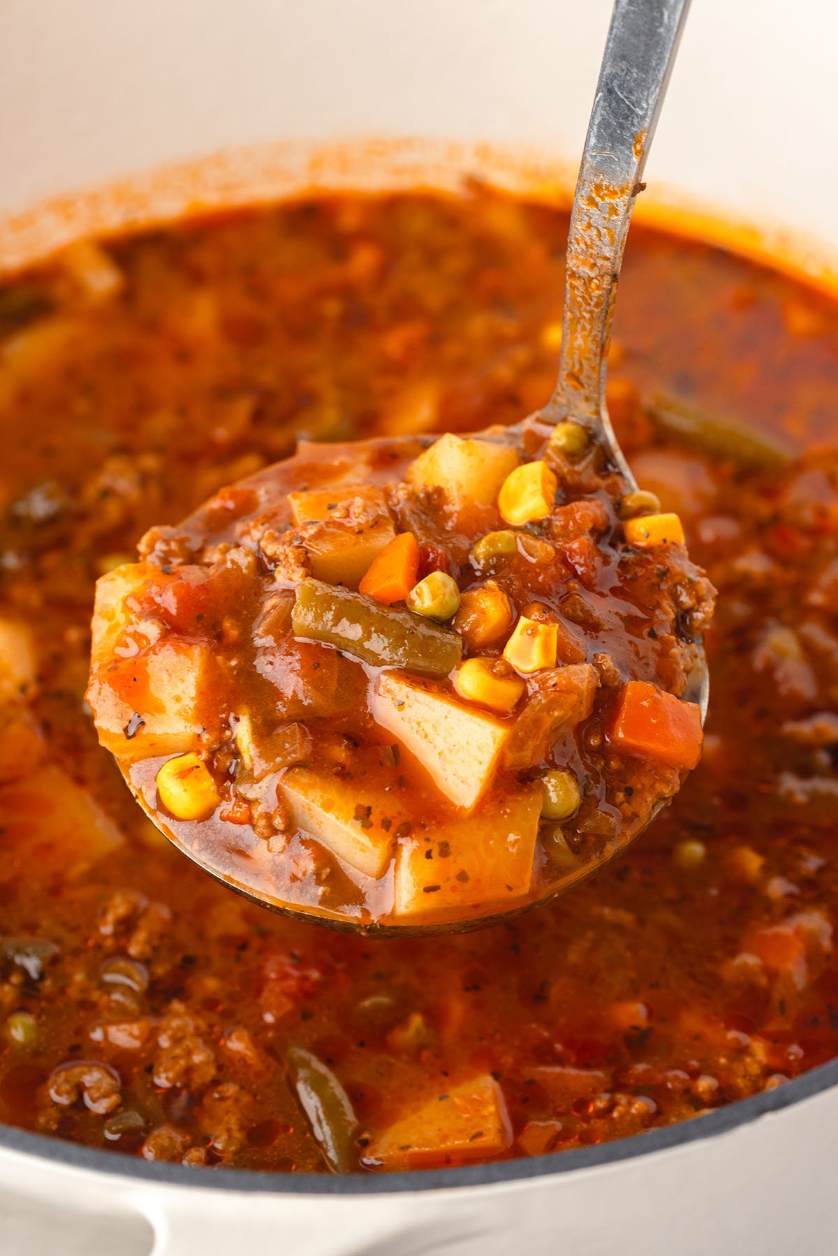 Hamburger Vegetable Soup is being served in a soup ladle.