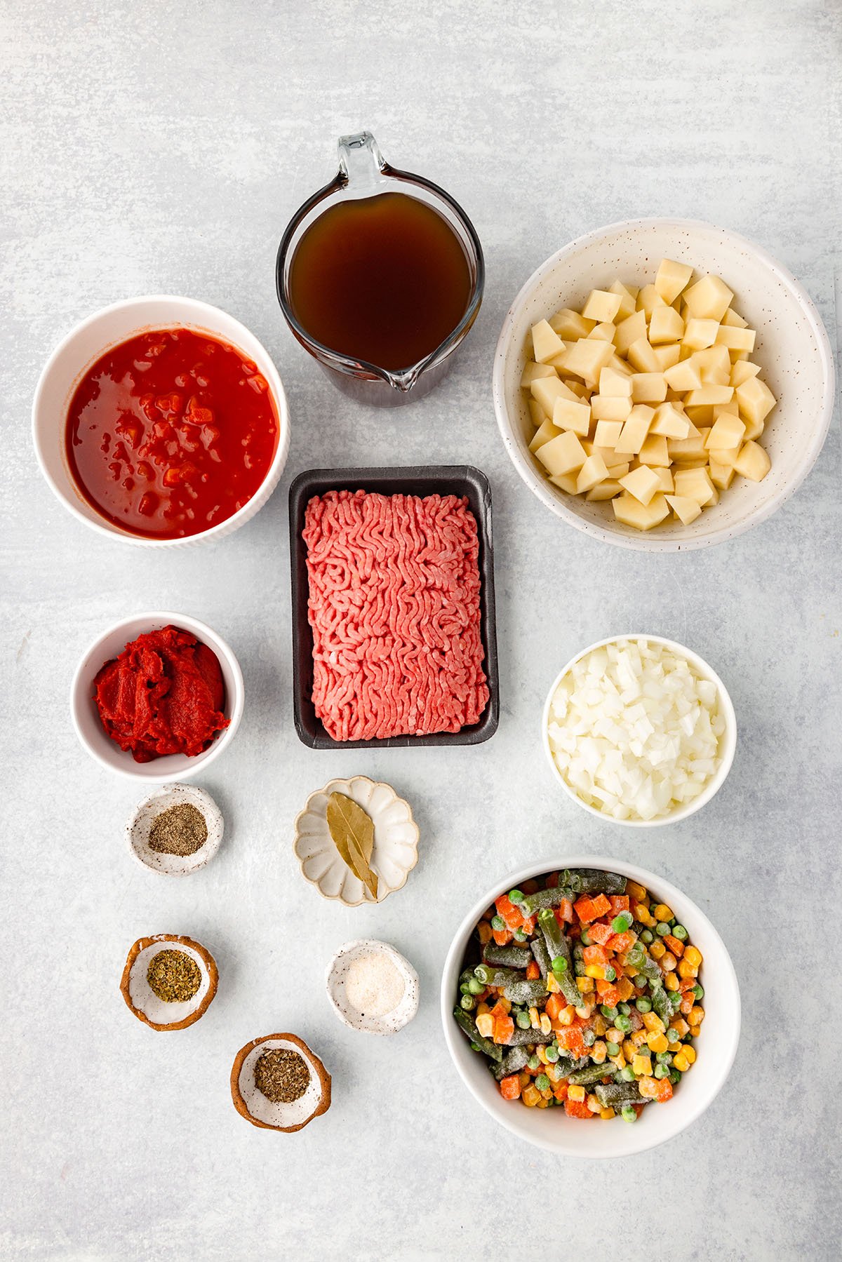 Ingredients to make Hamburger Vegetable Soup set out on the counter.
