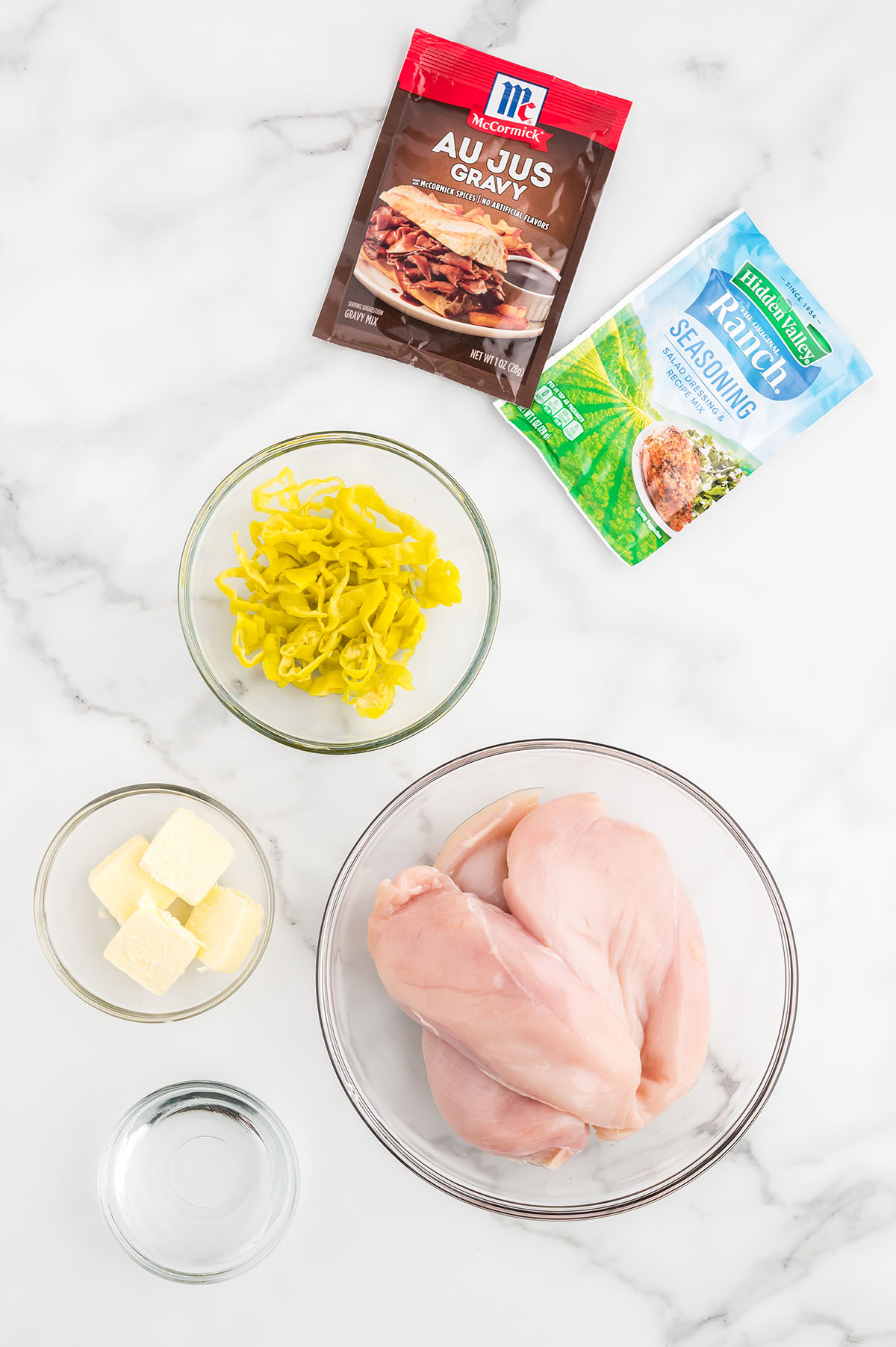 Ingredients to make slow cooker Mississippi chicken set out on the counter.