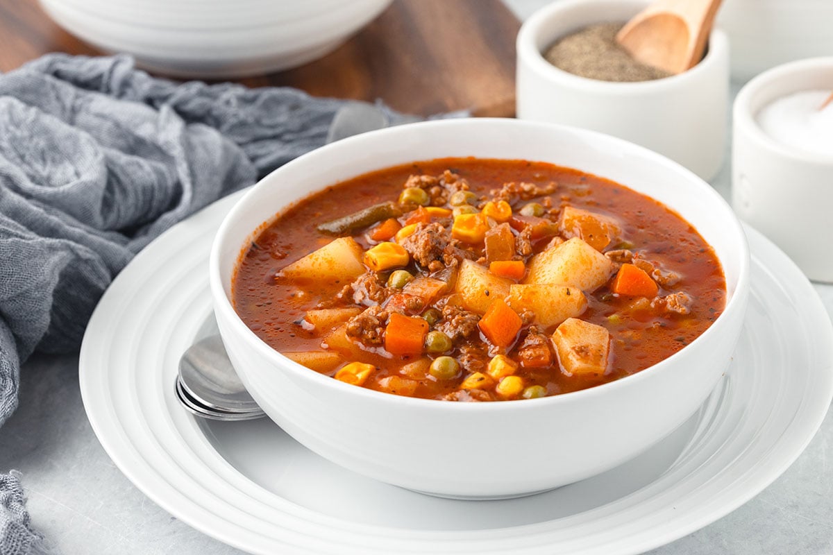 A serving of Hamburger Vegetable Soup in a white bowl.