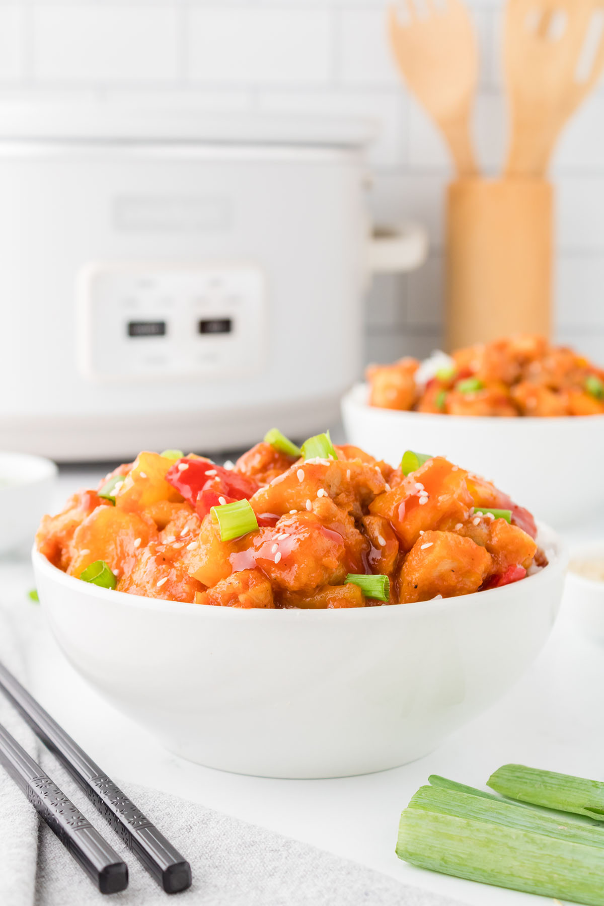 Sweet and sour chicken served in a white bowl.
