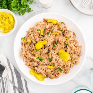 Mississippi chicken in a white serving bowl.