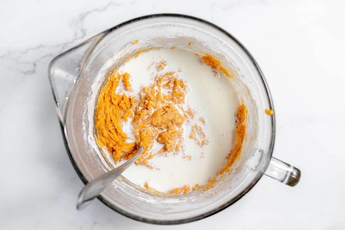 Milk was added to the sweet potato mixture in the mixing bowl.