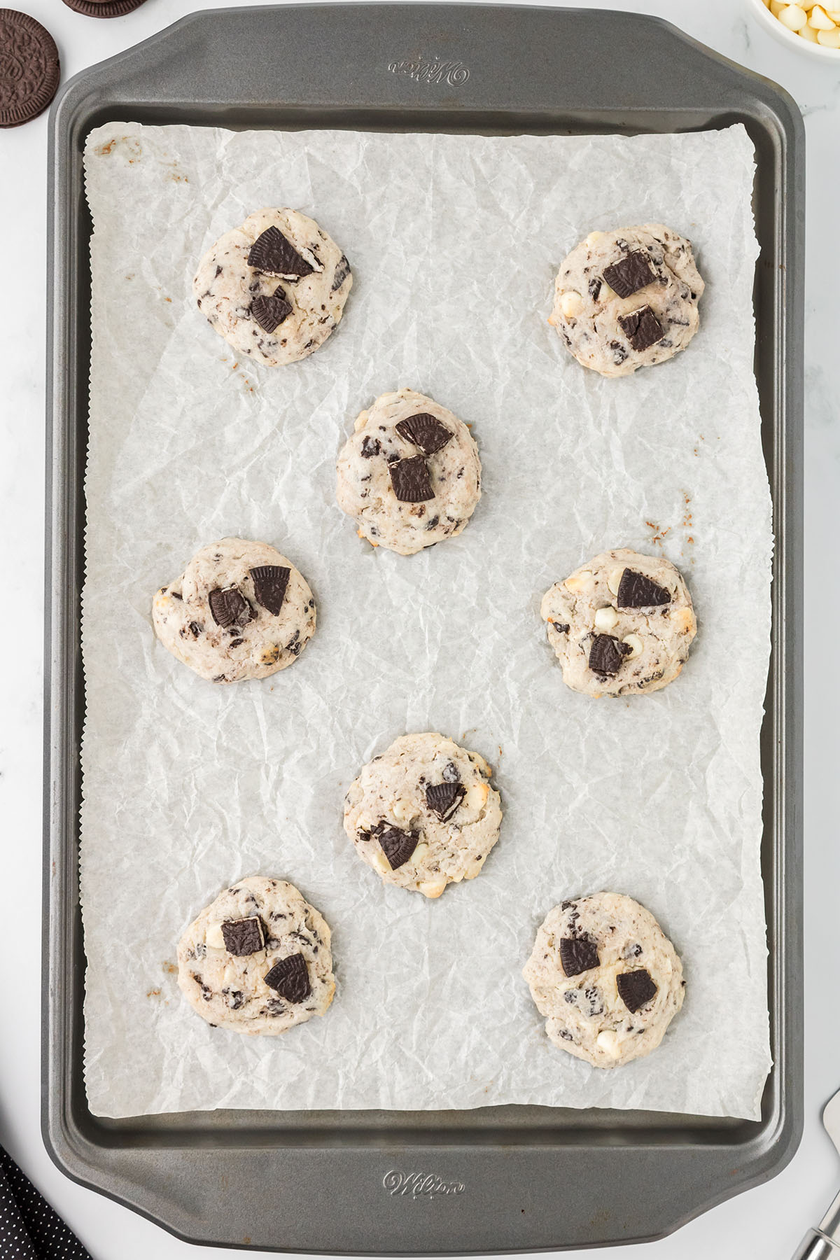 Baked cookies on a parchment paper lined baking sheet.