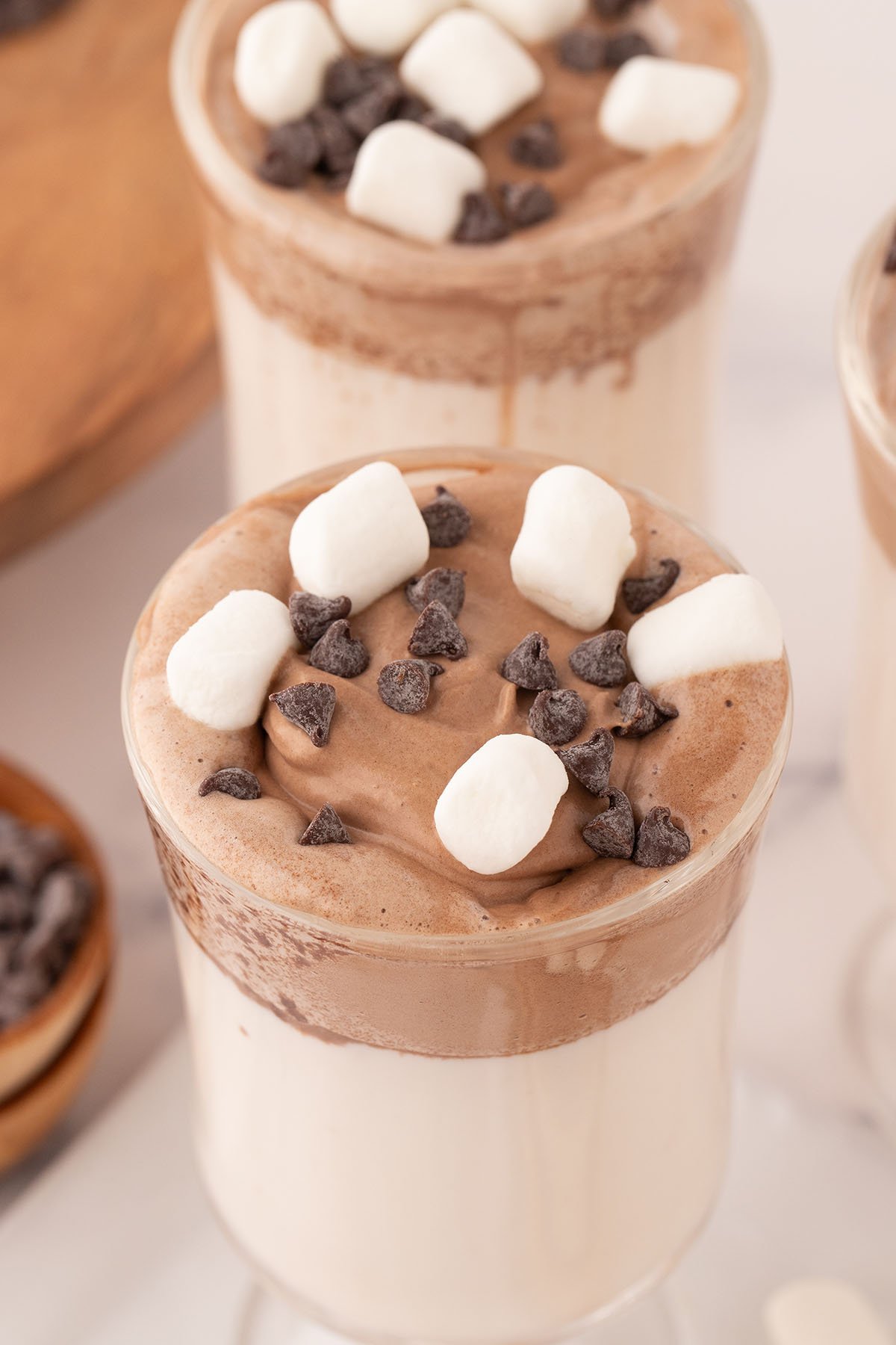 Whipped Hot Chocolate served topped with marshmallows and chocolate chips.