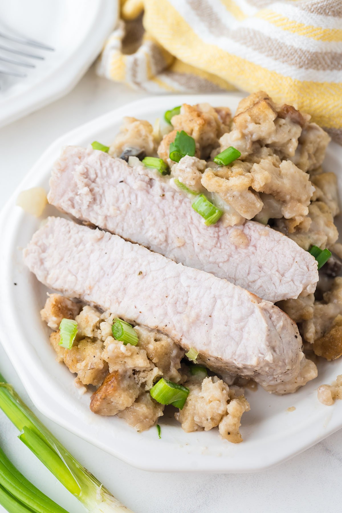 A Pork Chop and Stuffing served on a white plate.