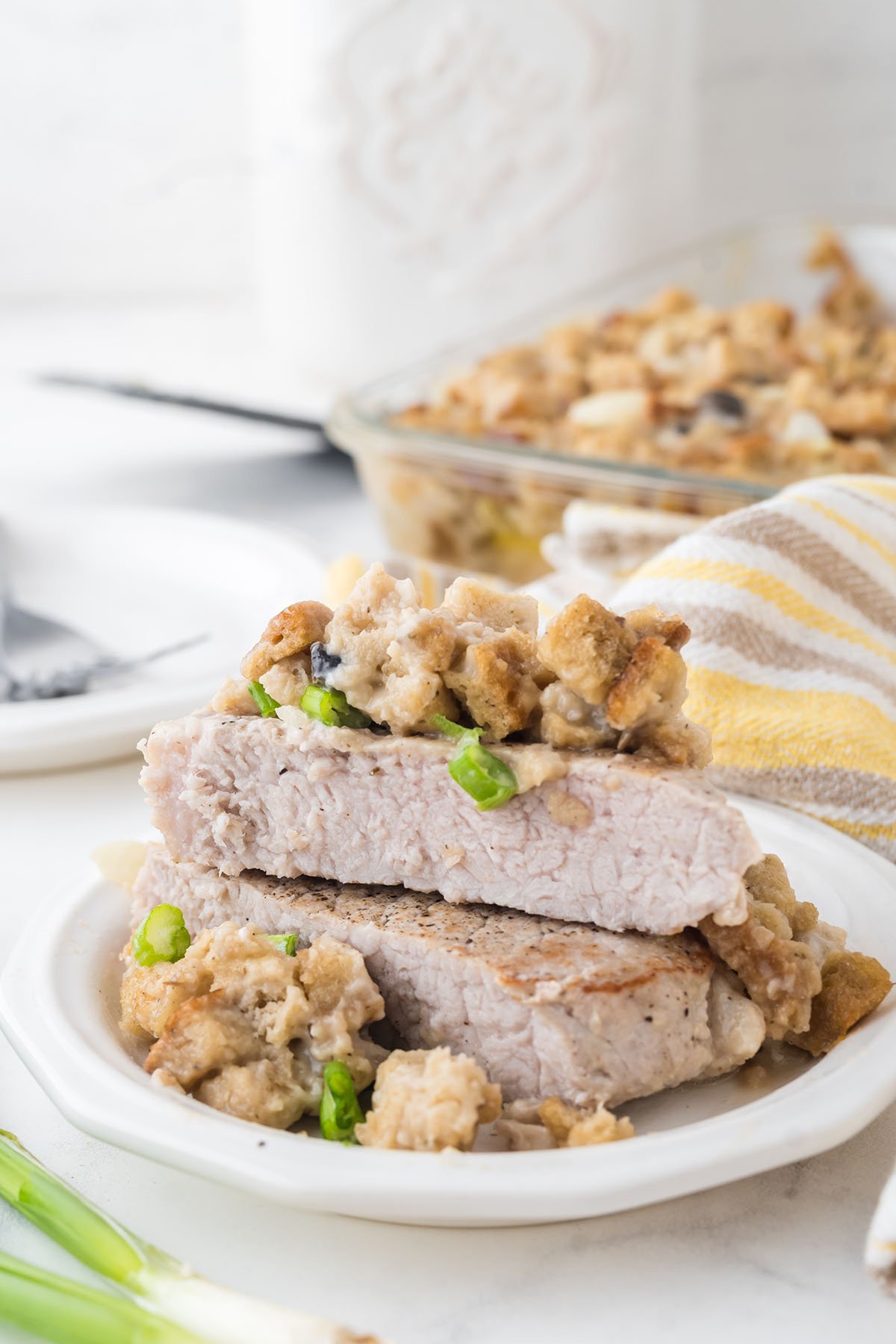 A Pork Chop and Stuffing served on a white plate.