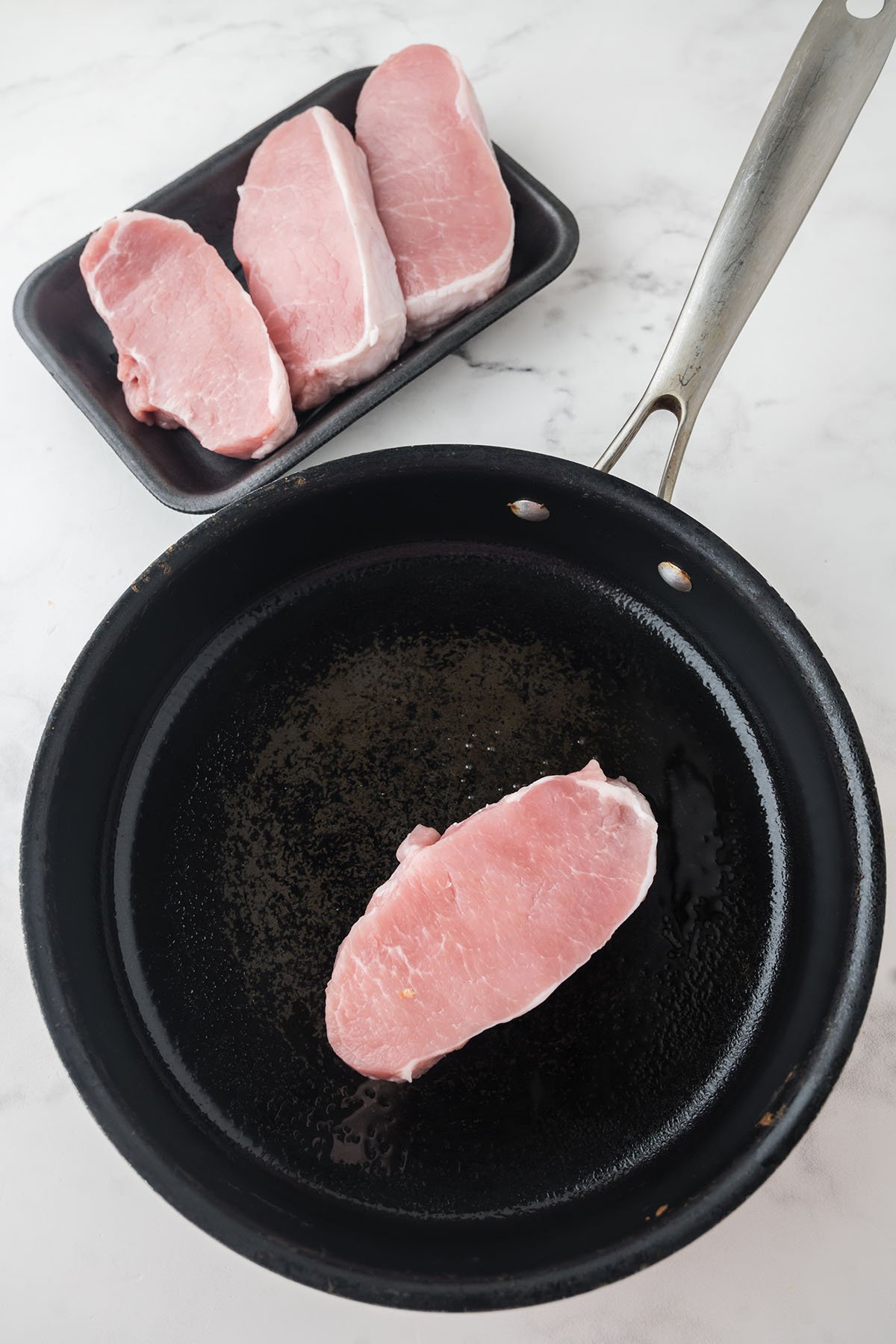 Pork chop in a skillet.