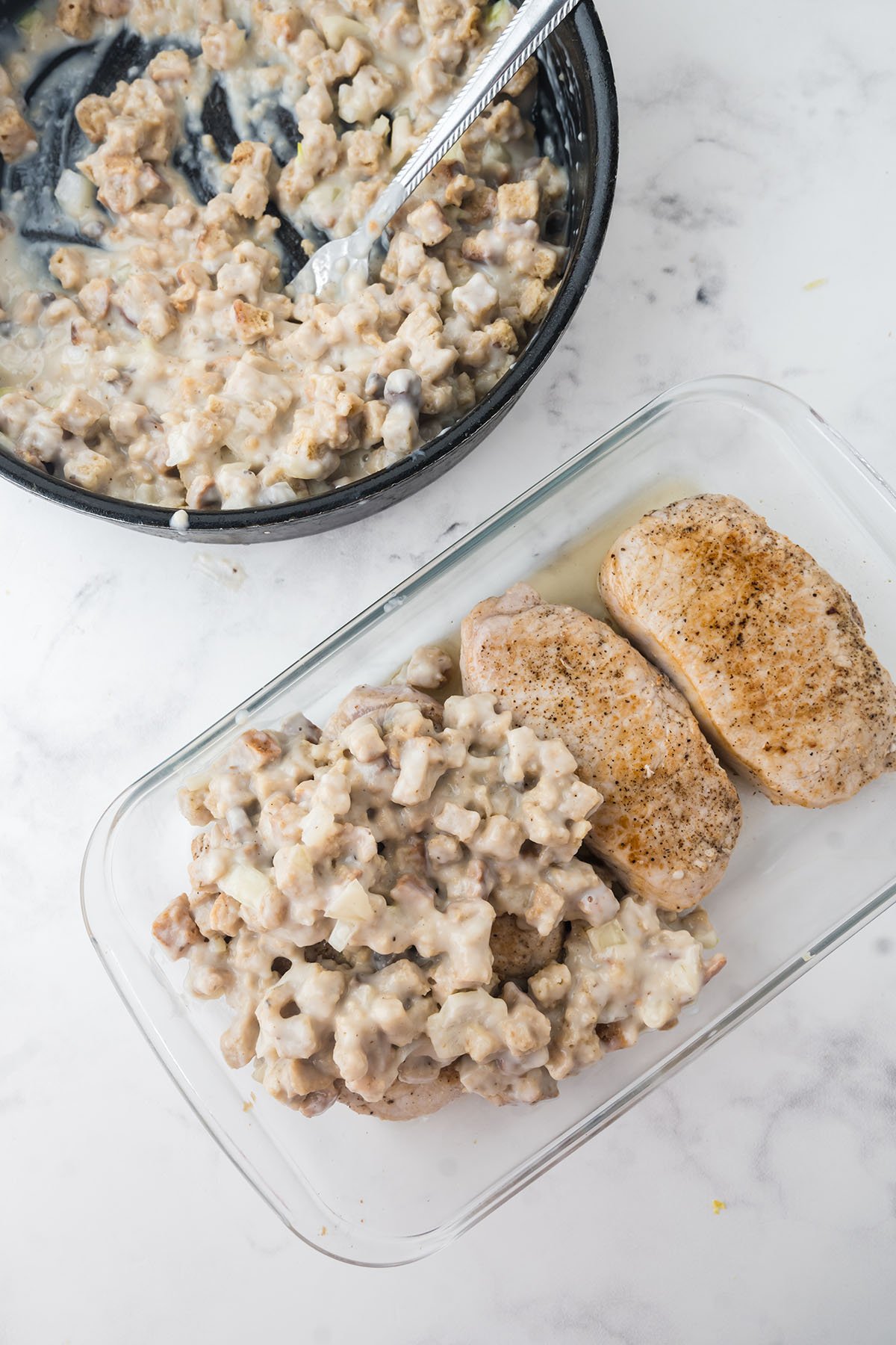 Stuffing added over the pork chops in the baking dish.