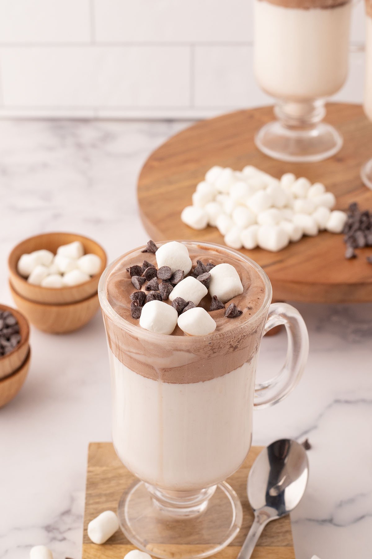 Whipped Hot Chocolate served topped with marshmallows and chocolate chips.
