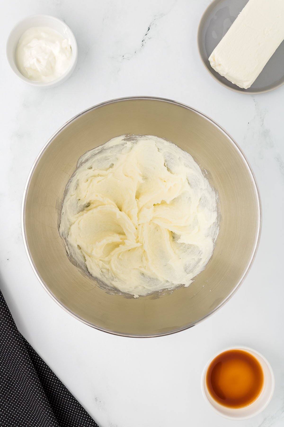 Butter and sugar are beaten together in a mixing bowl.