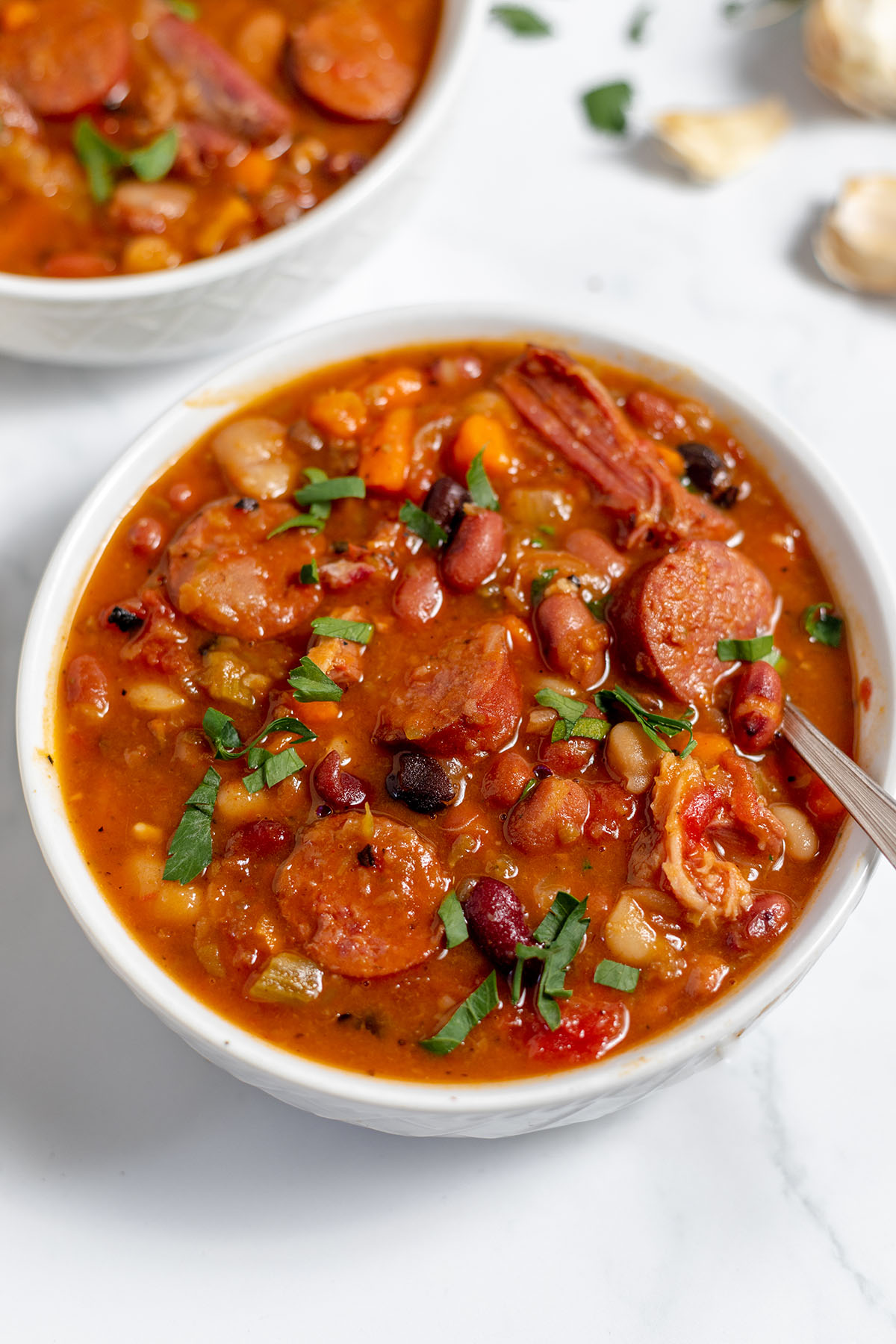 15 Bean Sausage and Ham Soup served in a white bowl.