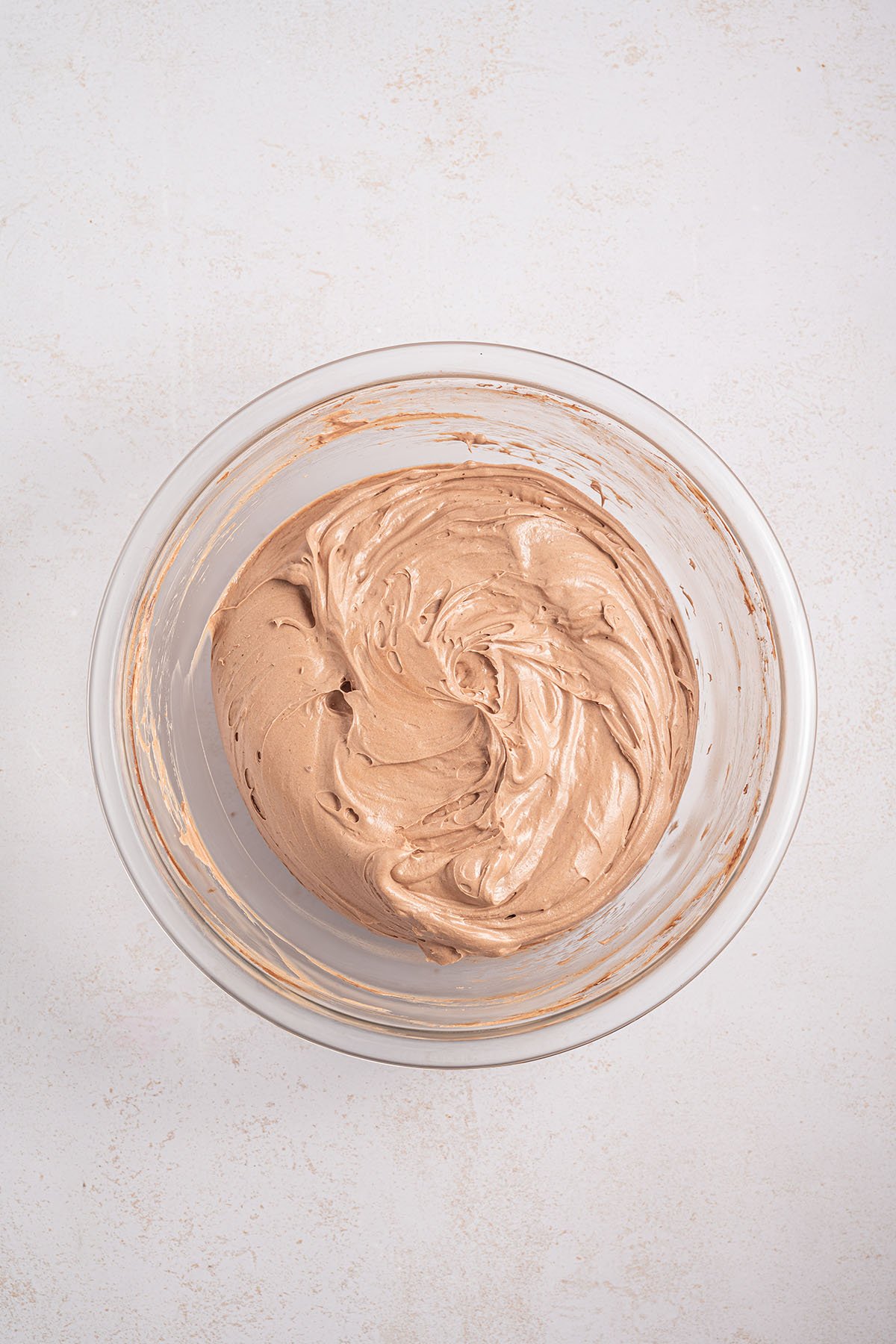 Chocolate Cheesecake Pie filling in a glass mixing bowl.
