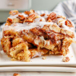 A serving of cinnamon roll casserole on a white plate.