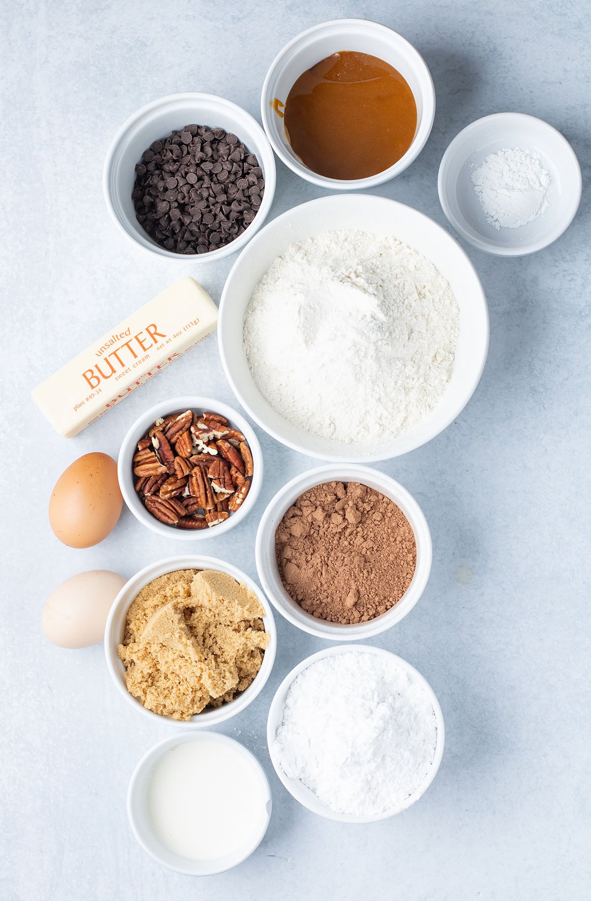Ingredients to make Caramel Pecan Brownie Donuts are set out on the counter.