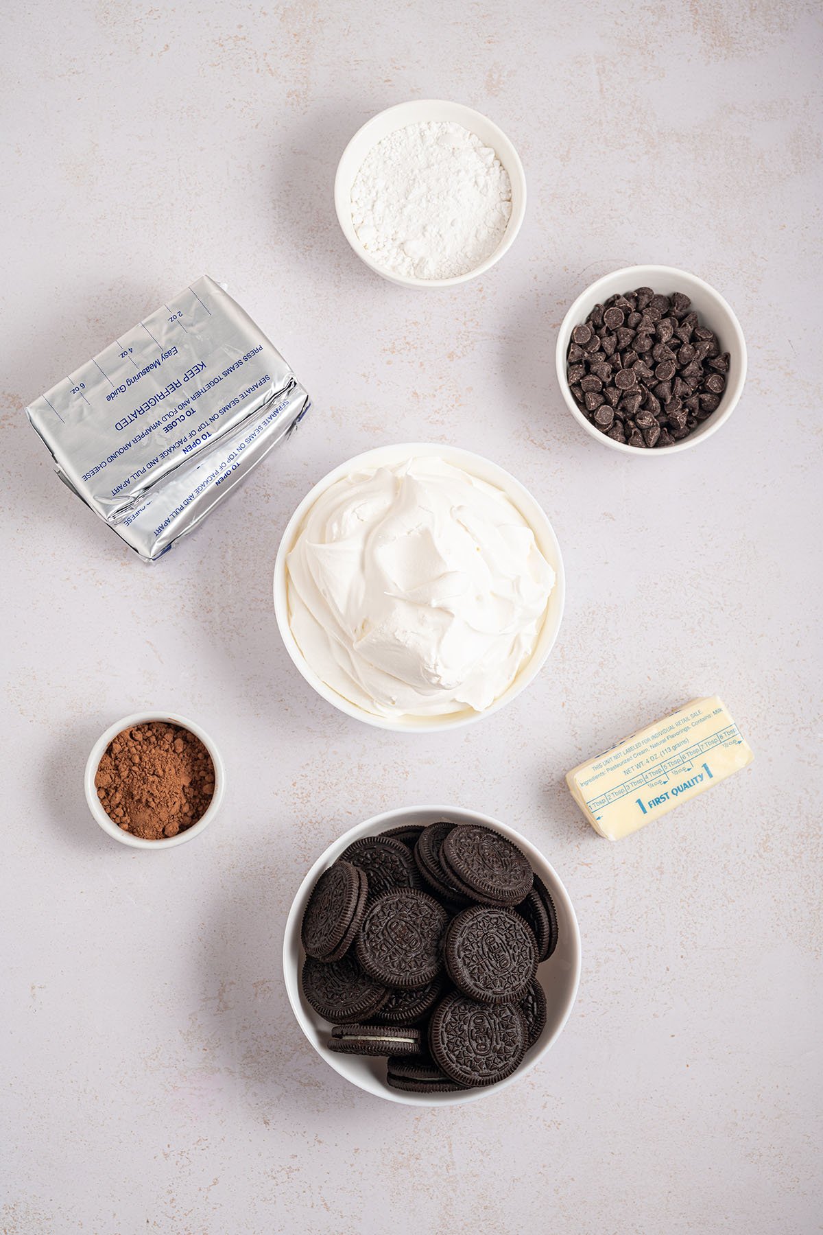 Ingredients to make Chocolate Cheesecake Pie are set out on the counter.