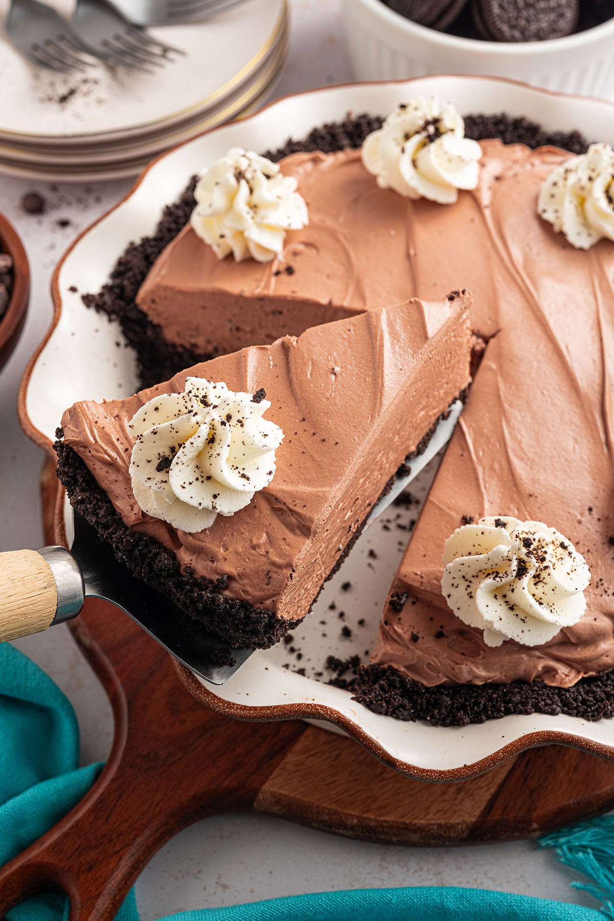 Chocolate Cheesecake in a pie plate with a slice on a pie server.