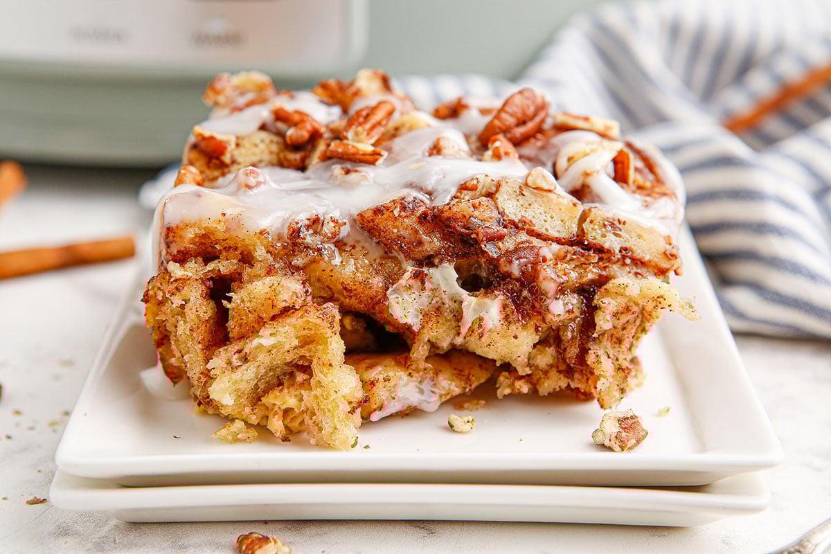 A slice of cinnamon roll casserole on a white plate.