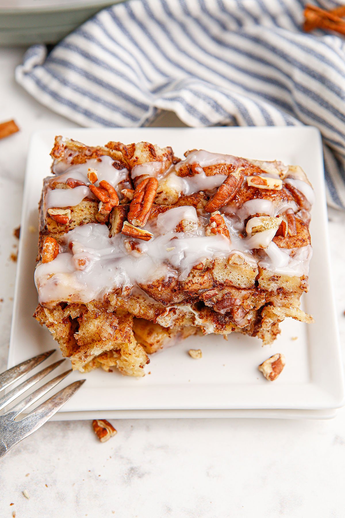 A slice of Cinnamon Roll Casserole served on a white plate.