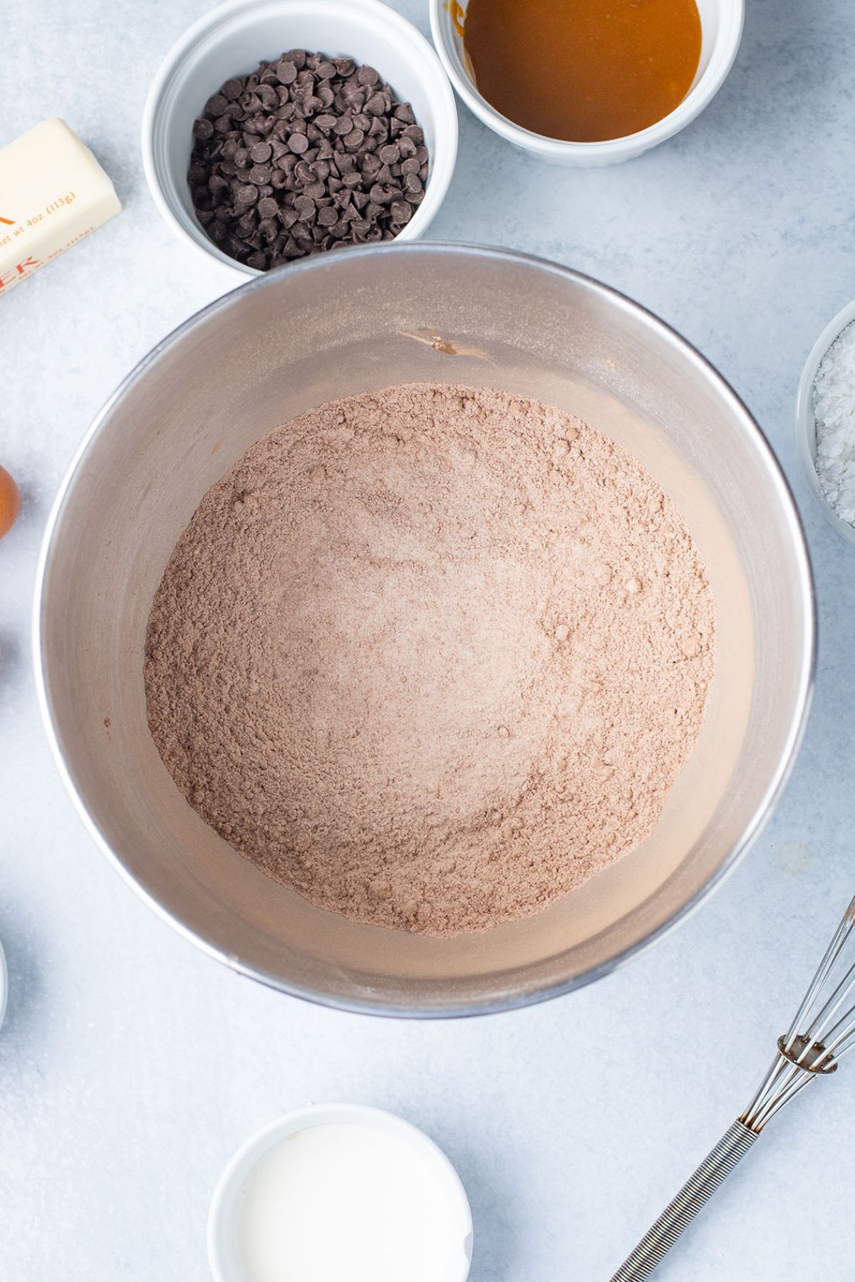 Flour, cocoa powder, brown sugar, and baking powder mixed together in a mixing bowl.