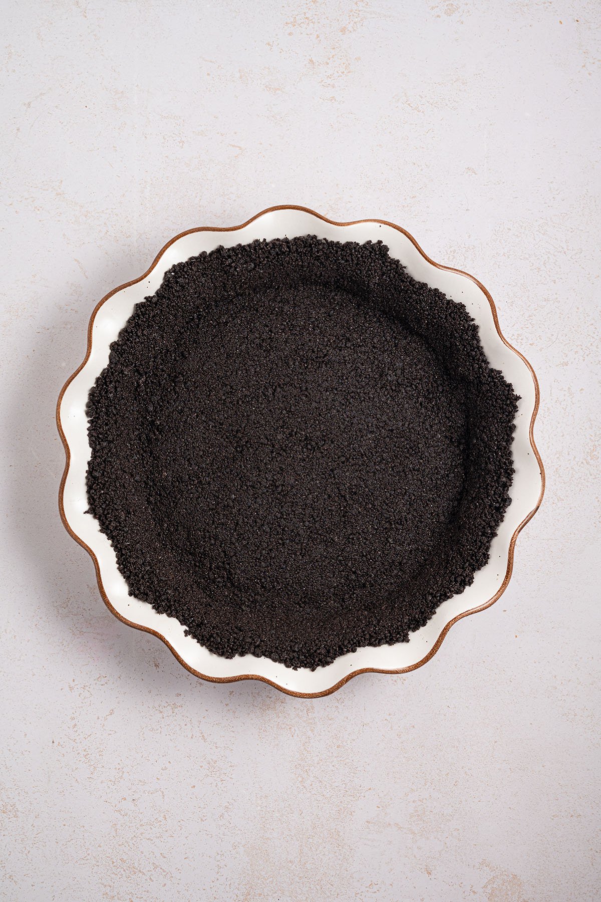 Oreo crust in a pie plate.