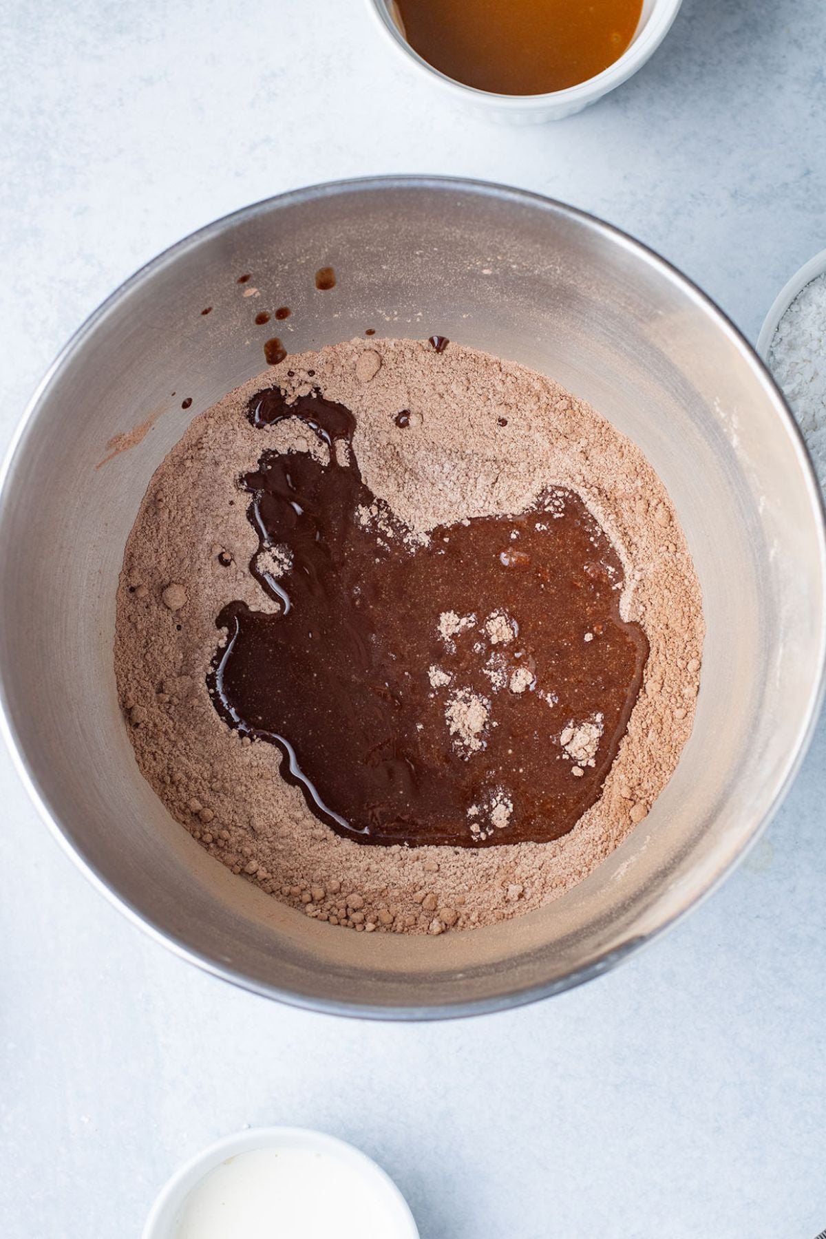 The wet ingredients added to the dry ingredients in the mixing bowl.