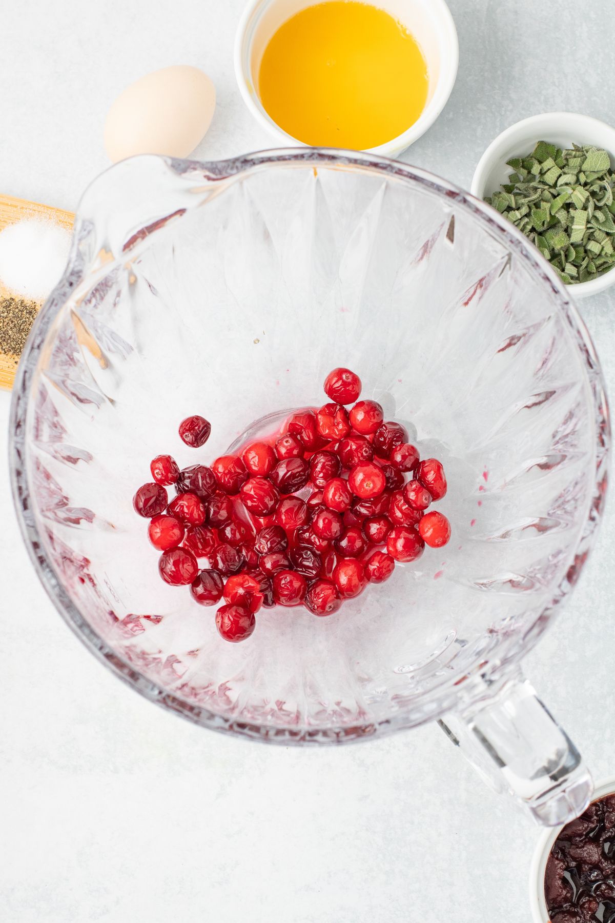 Cranberries in a glass mixing bowl.