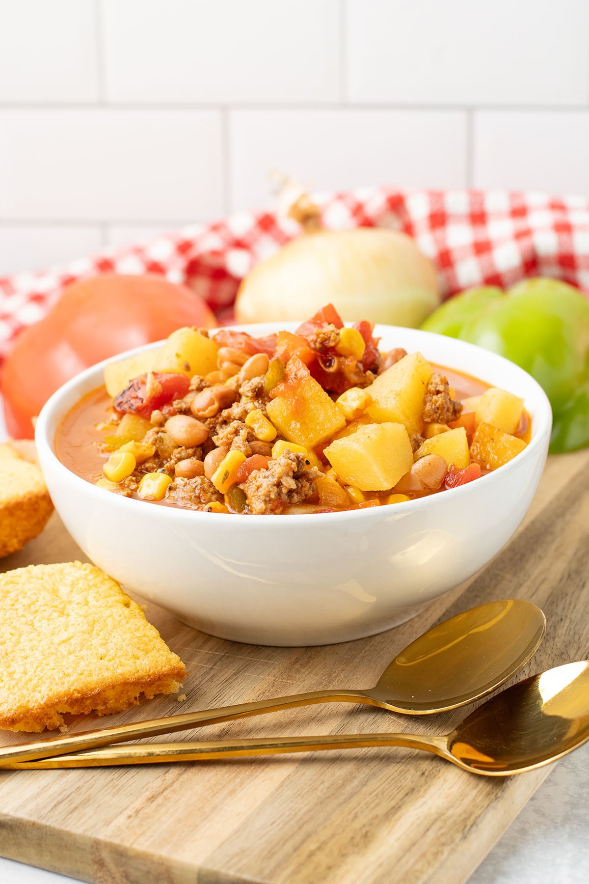 Cowboy Soup served in a white bowl on a wooden board.