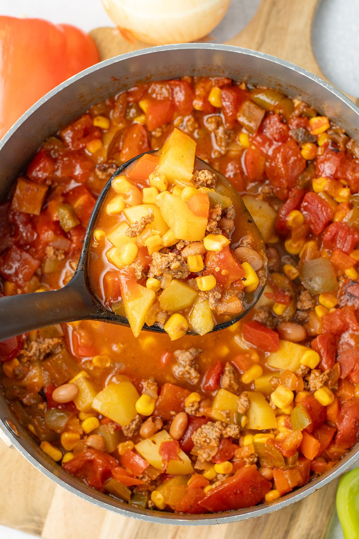 Cowboy Soup in a large pot is being served with a large ladle.