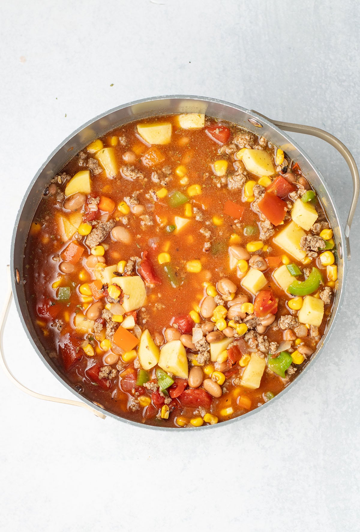 Cowboy soup ingredients simmering in a large pot.
