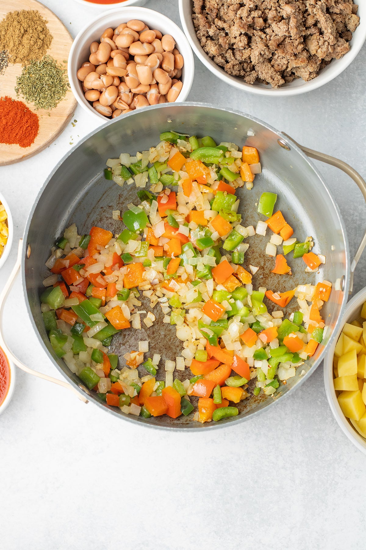 Diced onion, bell peppers, jalape&ntilde;o, and minced garlic in a large pot.