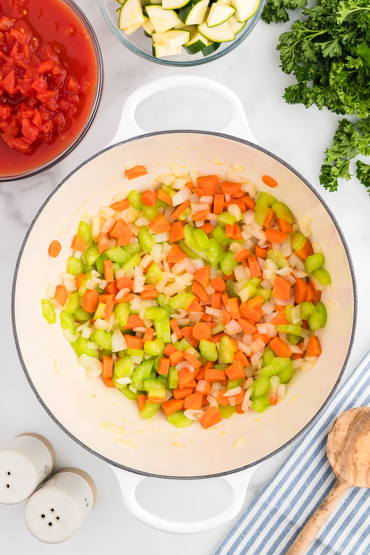 Diced onion, celery, and carrots in a large pot.