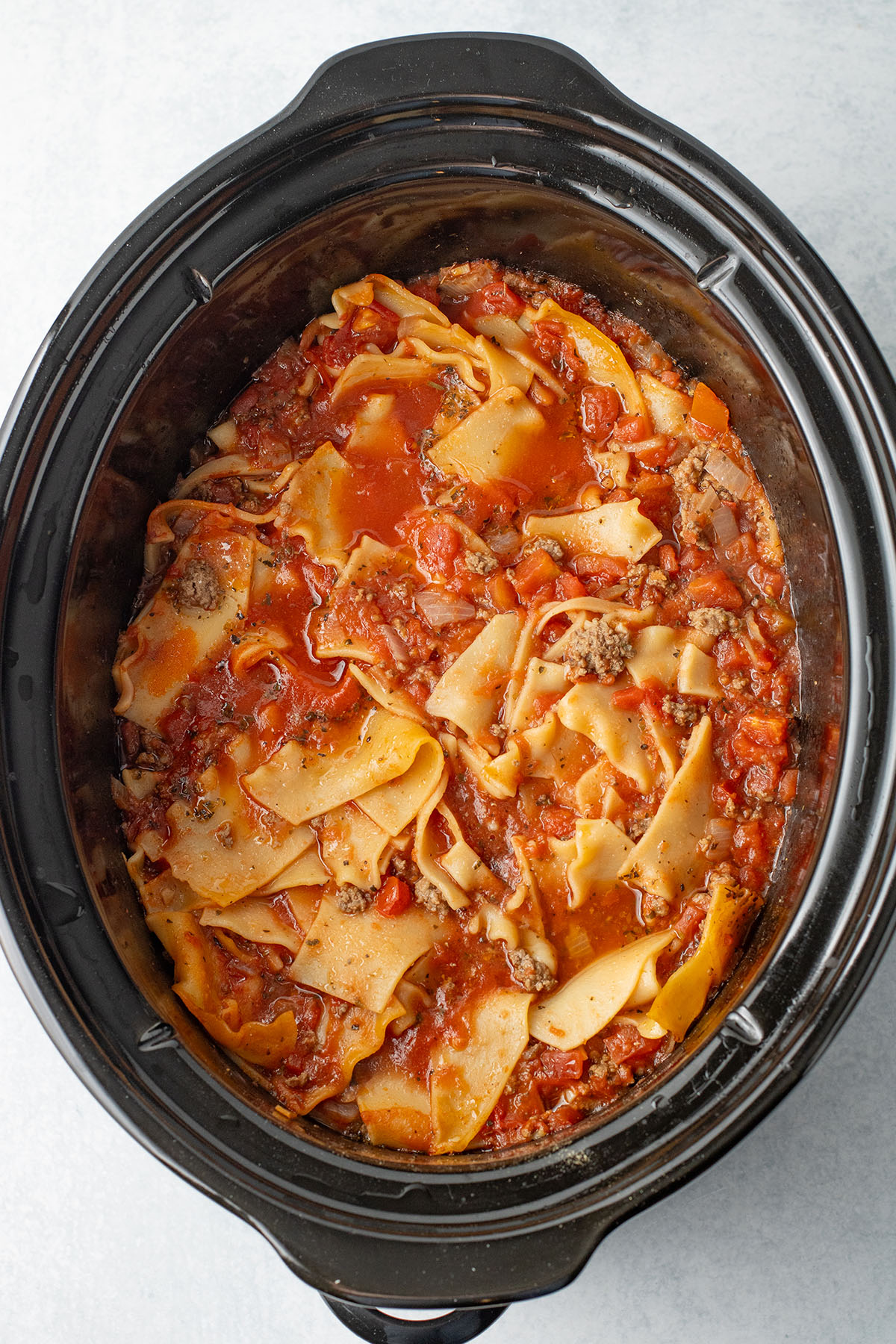 Cooked lasagna noodles in the soup in the slow cooker.
