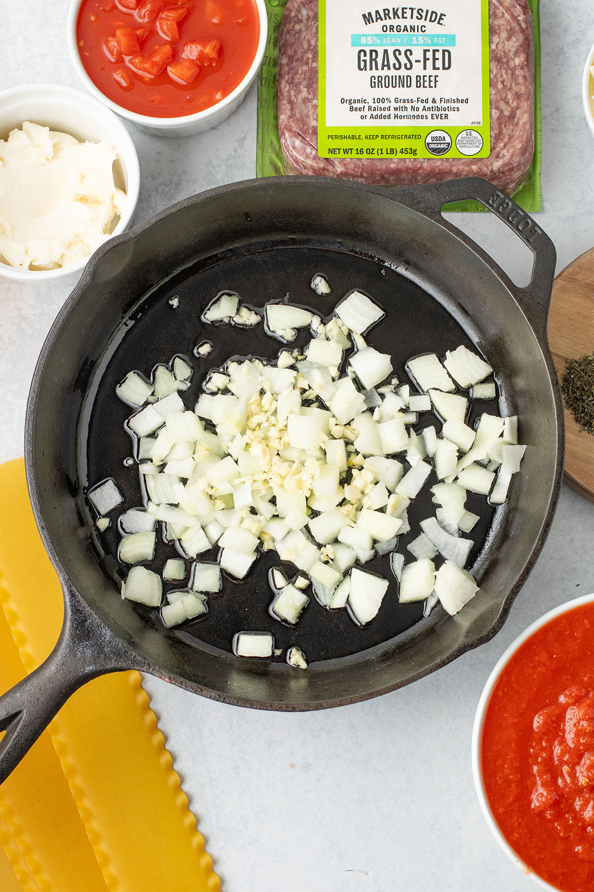 Diced onion and garlic in a cast iron skillet.