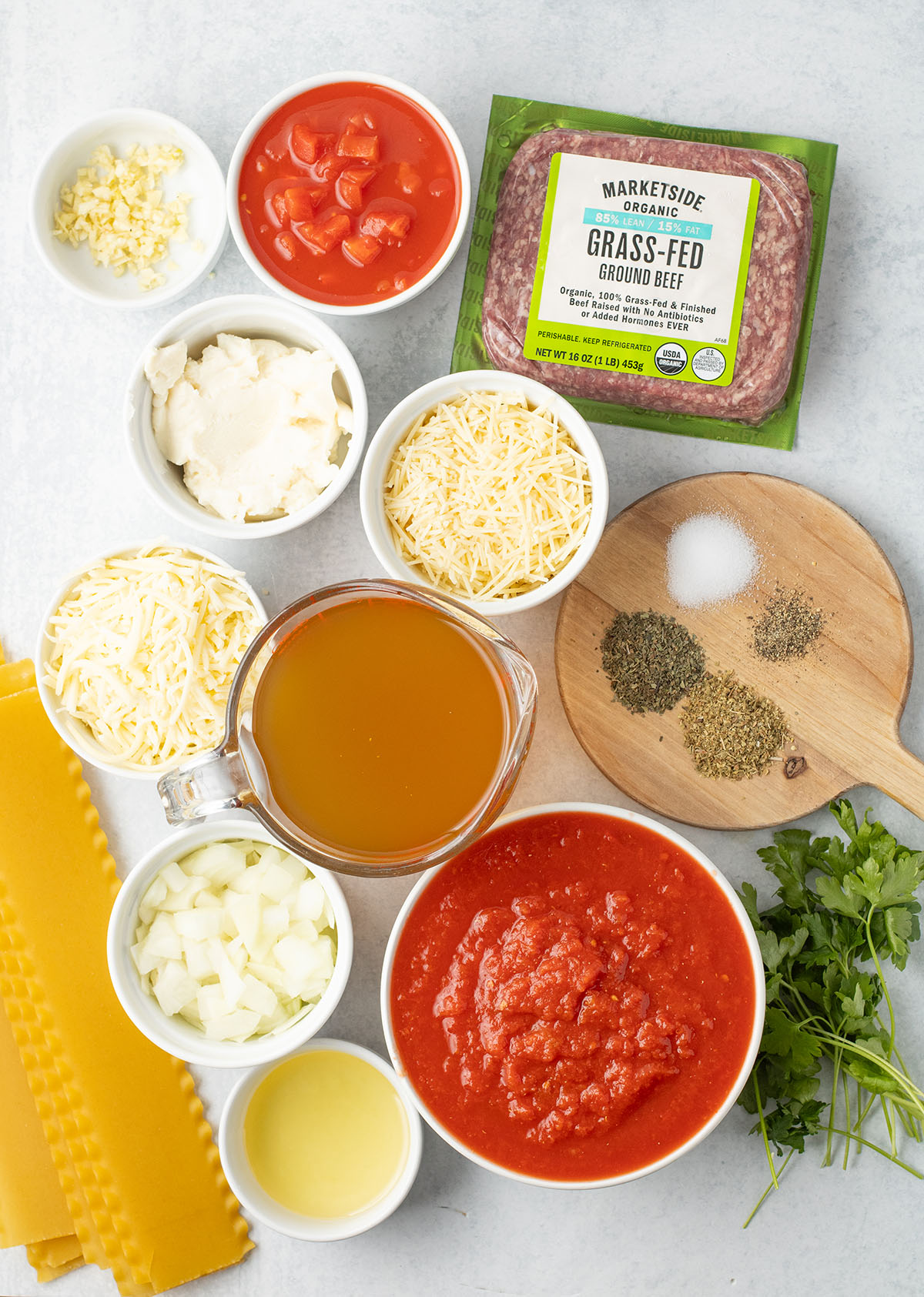 Ingredients to make slow cooker lasagna soup are set out on the counter.